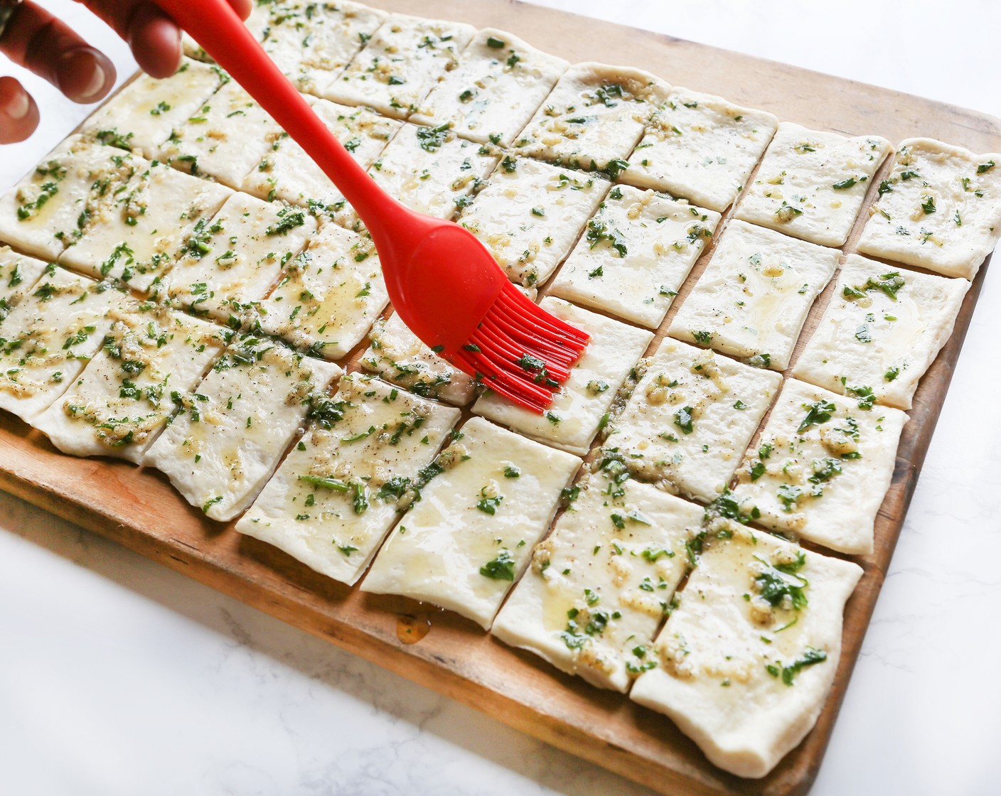 step 4 Use a pastry brush to spread the butter mixture evenly over the surface of the dough.