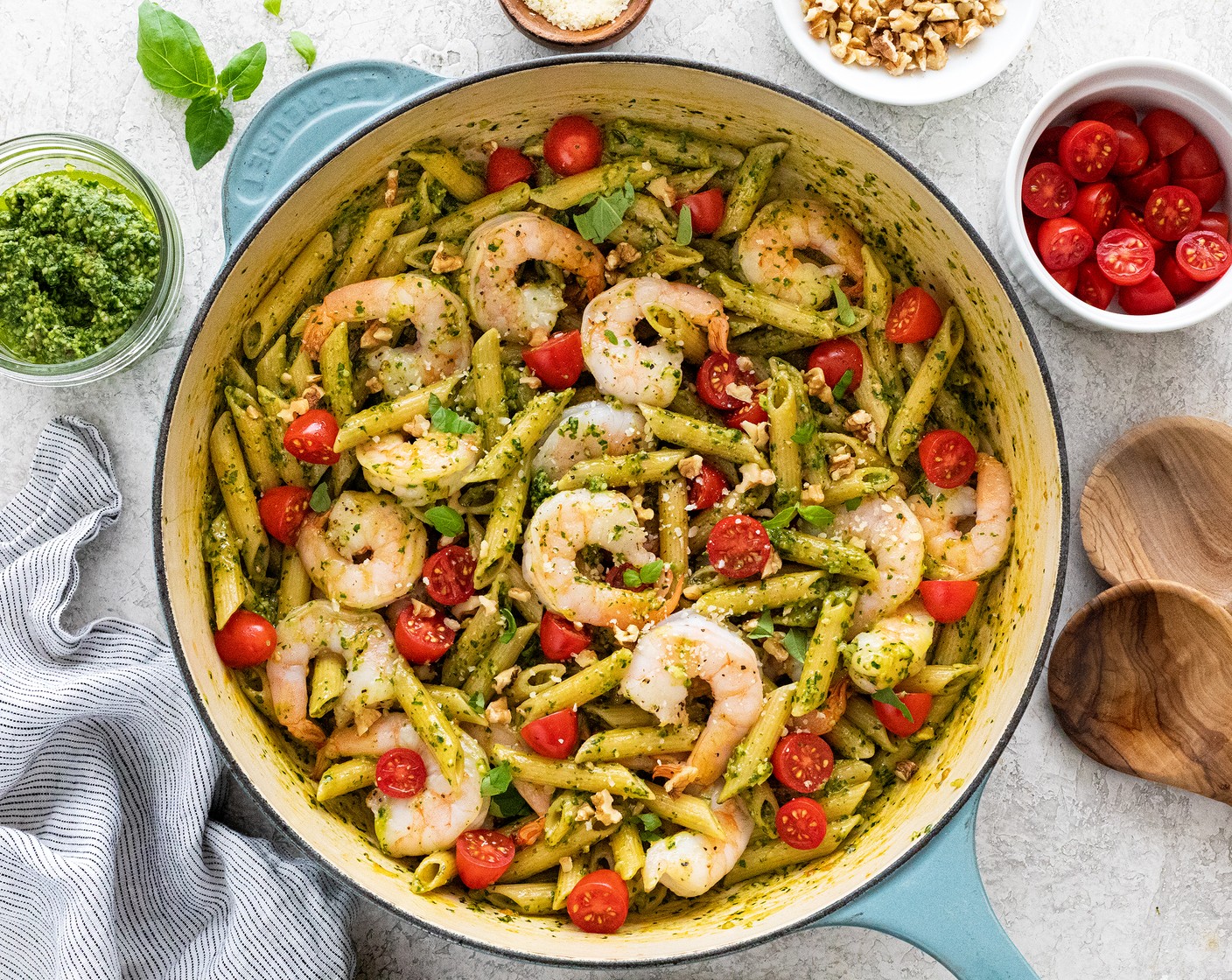 step 7 Add the Cherry Tomato (1 cup) evenly over the pasta, and garnish with additional basil leaves, chopped walnuts, and parmesan cheese if desired. Portion out the shrimp pesto pasta into bowls and serve immediately.