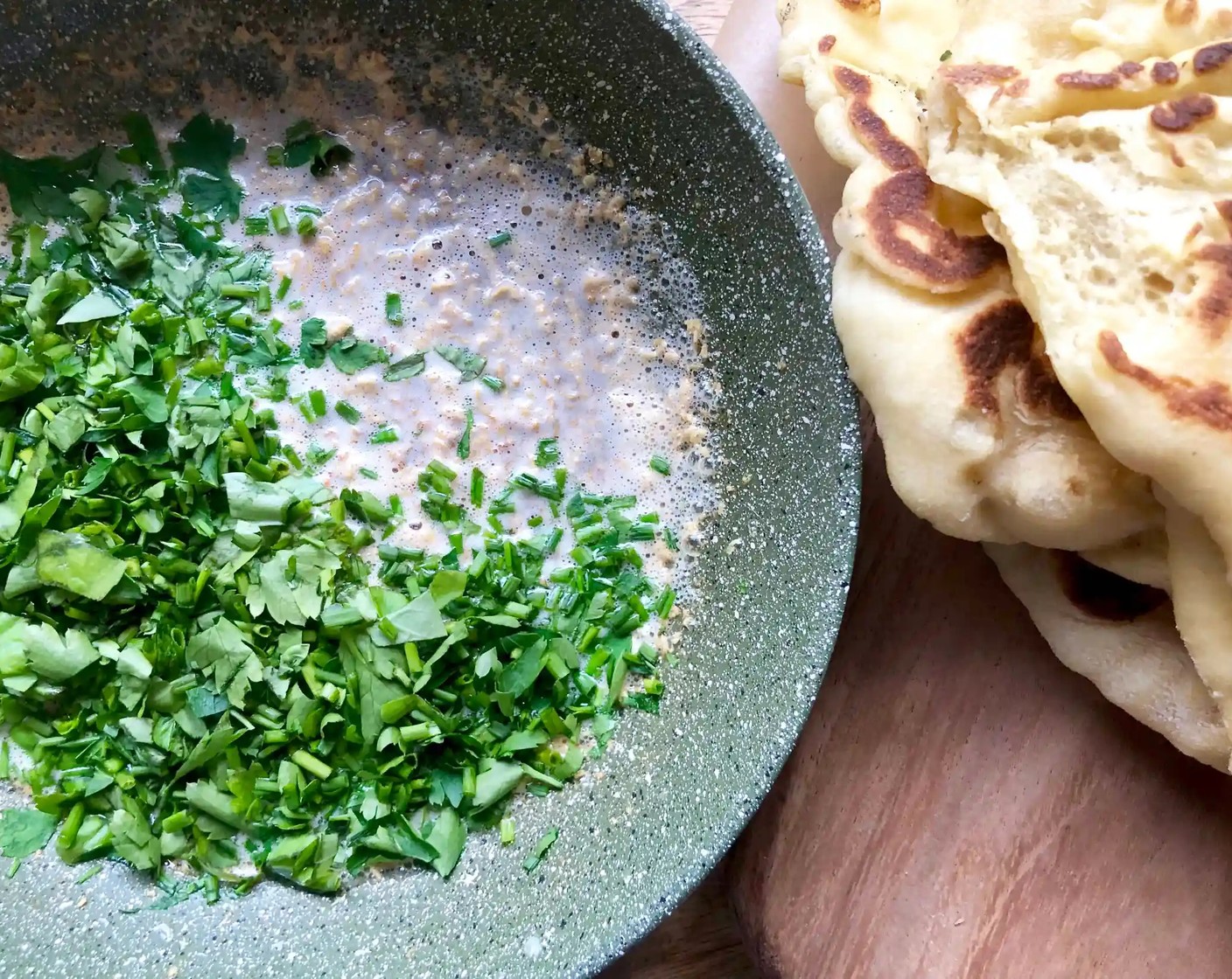 step 14 Remove from the heat and add the Fresh Herbs (3/4 cup). Brush the garlic herb butter over the warm naan and serve.