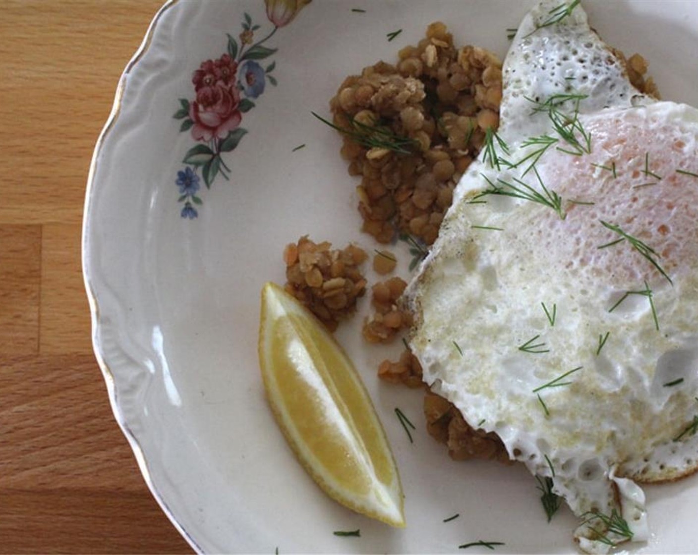 step 3 Divide lentils between two plates and top with eggs, Fresh Dill (1/2 Tbsp), and a squeeze of Lemons (2 slices).