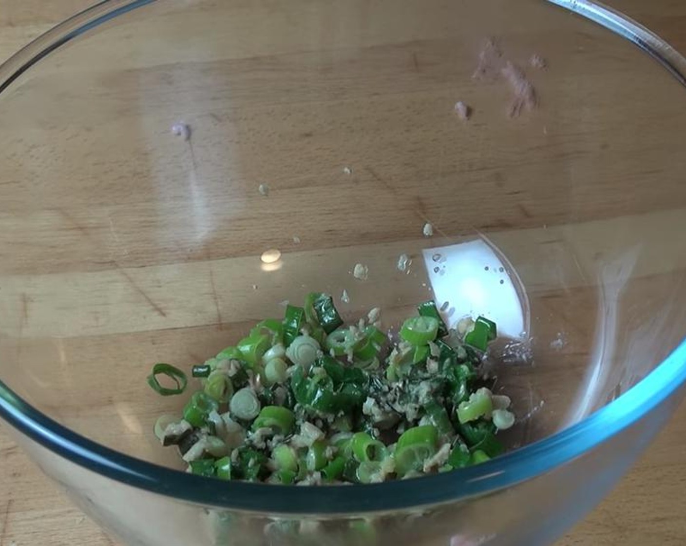 step 1 In a large frying pan over medium heat, add Olive Oil (as needed), Garlic (2 cloves), and Scallion (1 bunch). Cook while occasionally stirring for about a minute, or until the onions soften.