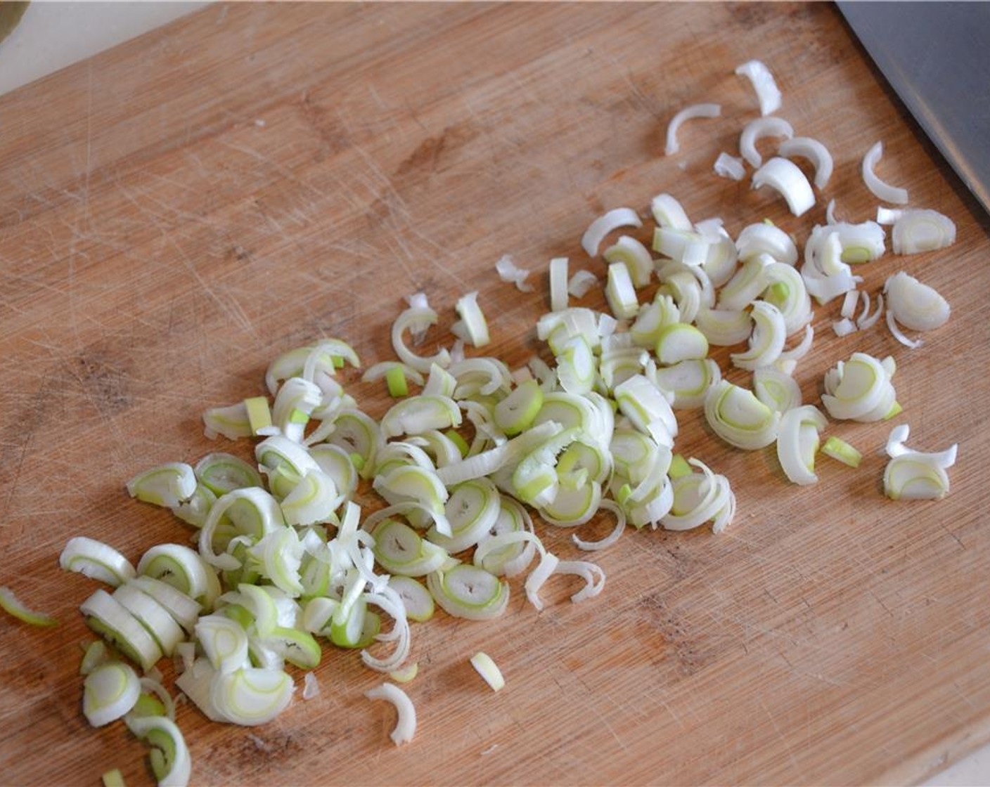 step 2 Wash the Leek (1) and thinly slice the white and green parts only. Reserve the top for making stocks.