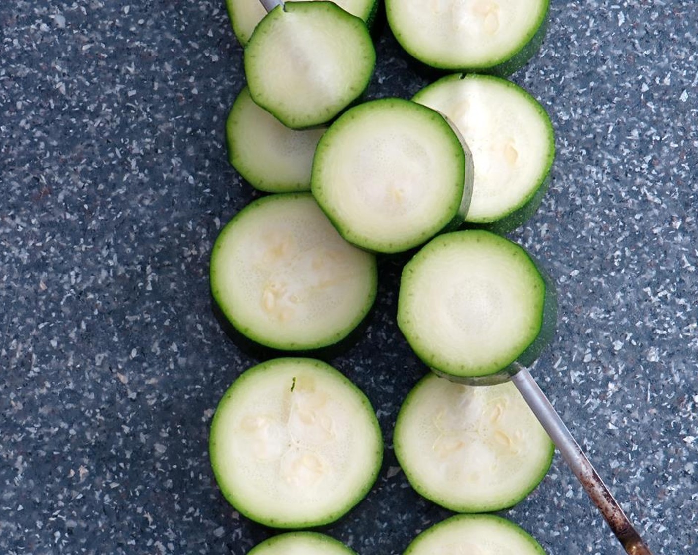 step 5 Slice the Zucchini (1) into rounds, crosswise about 1/2 to 3/4" thick.