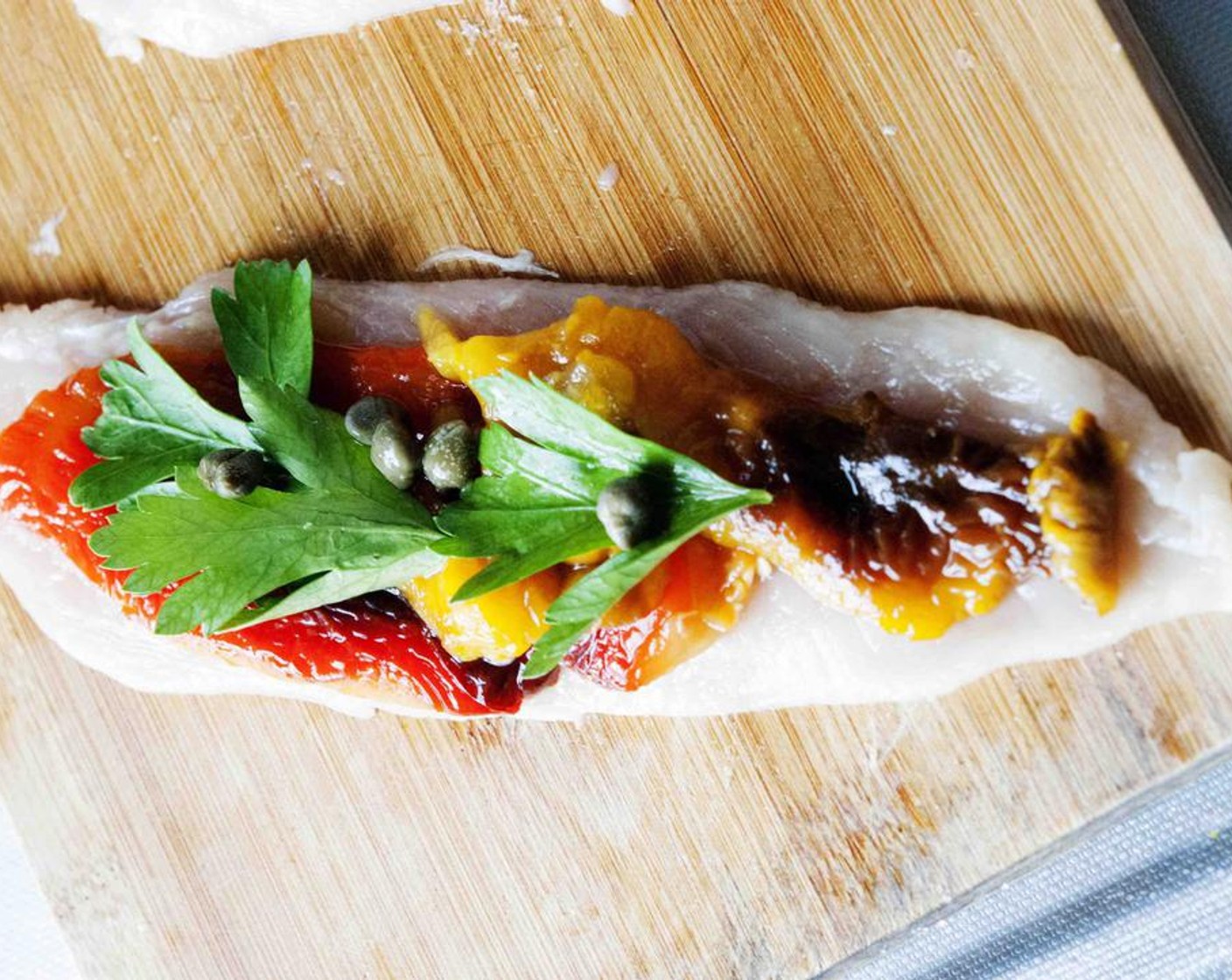 step 3 On each slice of chicken place a slice of red and a slice of yellow bell peppers, some Capers (1 Tbsp) and Italian Flat-Leaf Parsley (to taste).