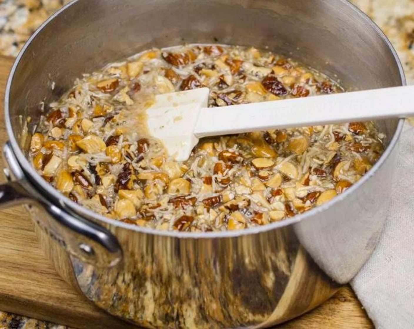 step 10 Remove from heat and add Pure Vanilla Extract (1 tsp), Roasted Nuts, and Unsweetened Coconut Flakes (1 1/2 cups). Allow to cool and thicken slightly, about 30 minutes.