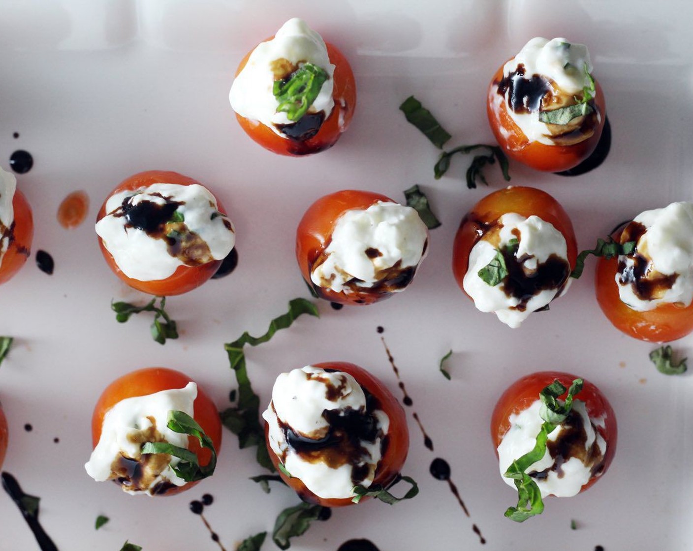 step 7 Serve the filled tomatoes on a platter drizzled with the balsamic reduction. Sprinkle the top with Fresh Basil (2 Tbsp). Enjoy!