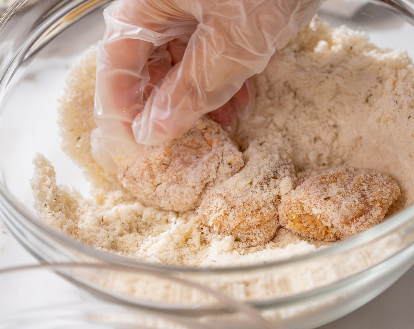 step 6 Dredge each chicken cube in the almond flour mixture. Use your hand to press down to make sure that they are fully coated on all sides.