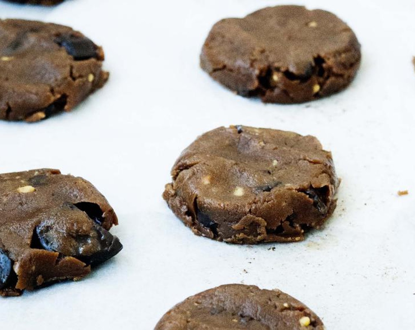 step 5 Use a medium cookie scoop to scoop dough onto parchment-lined baking sheet. Barely flatten the tops of the cookies with the tips of your fingers. Bake for 12 minutes or until edges is slightly golden brown.