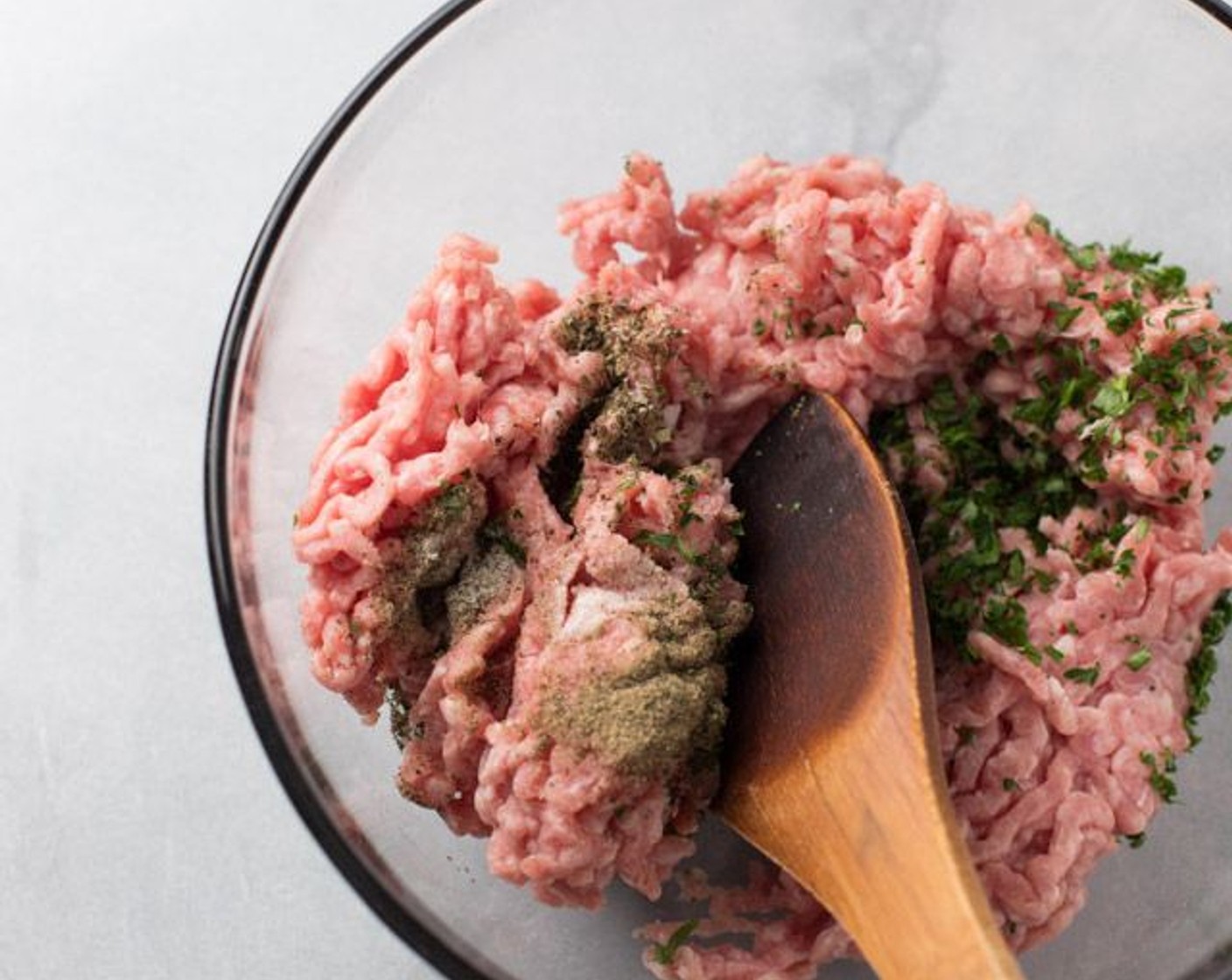 step 2 In a large mixing bowl, combine the Ground Pork (1 lb), Onion Salt (1/4 tsp), Freshly Ground Black Pepper (1/4 tsp), Fresh Marjoram (1/2 tsp), and Fresh Parsley (1/2 Tbsp).