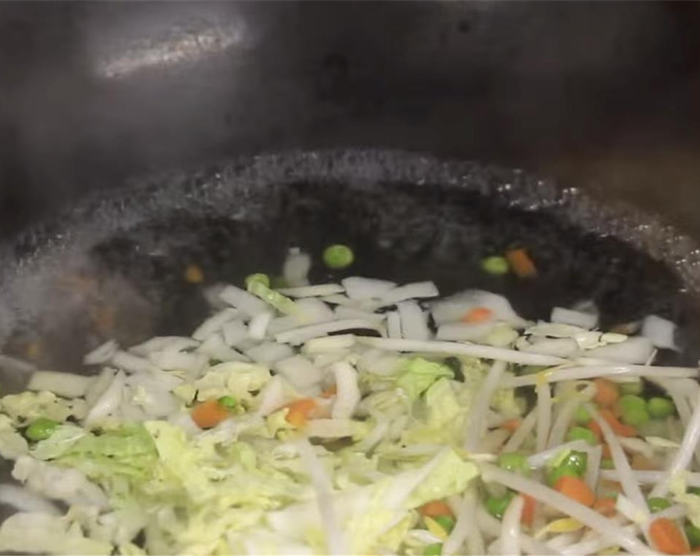 step 10 In a pot or wok of boiling water, start by blanching the onions for 5 to 10 seconds. Add in the Bean Sprouts (2 1/2 Tbsp) and Frozen Peas and Carrots (2 Tbsp) and blanch for 20 seconds and drain.