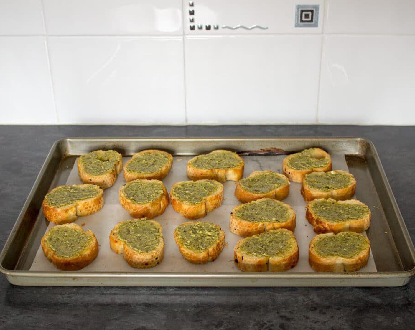 step 4 When the slices are ready, smear a good dollop of Basil Pesto (1/3 cup) onto the top of each one.