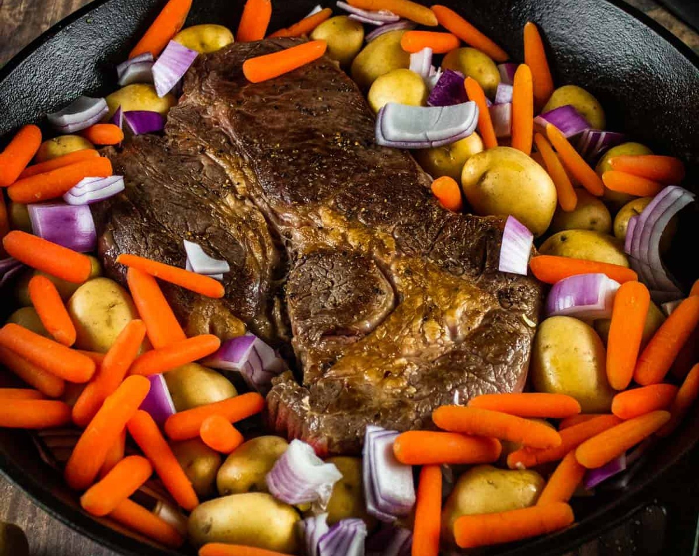 step 3 Remove pan from the heat and add Baby Potatoes (2 lb), Baby Carrots (1 3/4 cups), and Red Onion (1/2) to it around the beef.