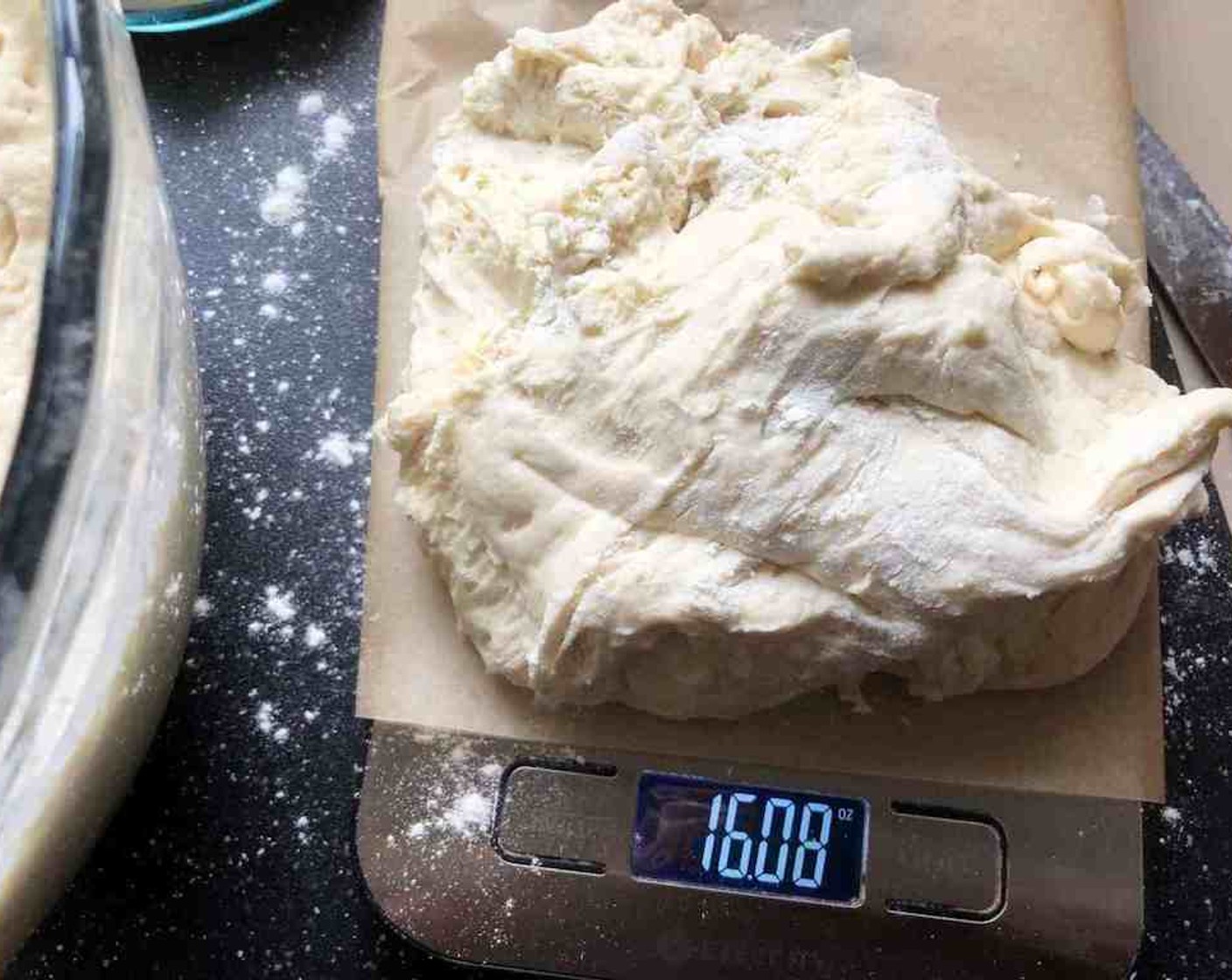 step 5 Grab that refrigerated container of prepared dough and sprinkle the surface of the dough with flour. Pull up and cut off a piece of dough weighing about 16 oz.