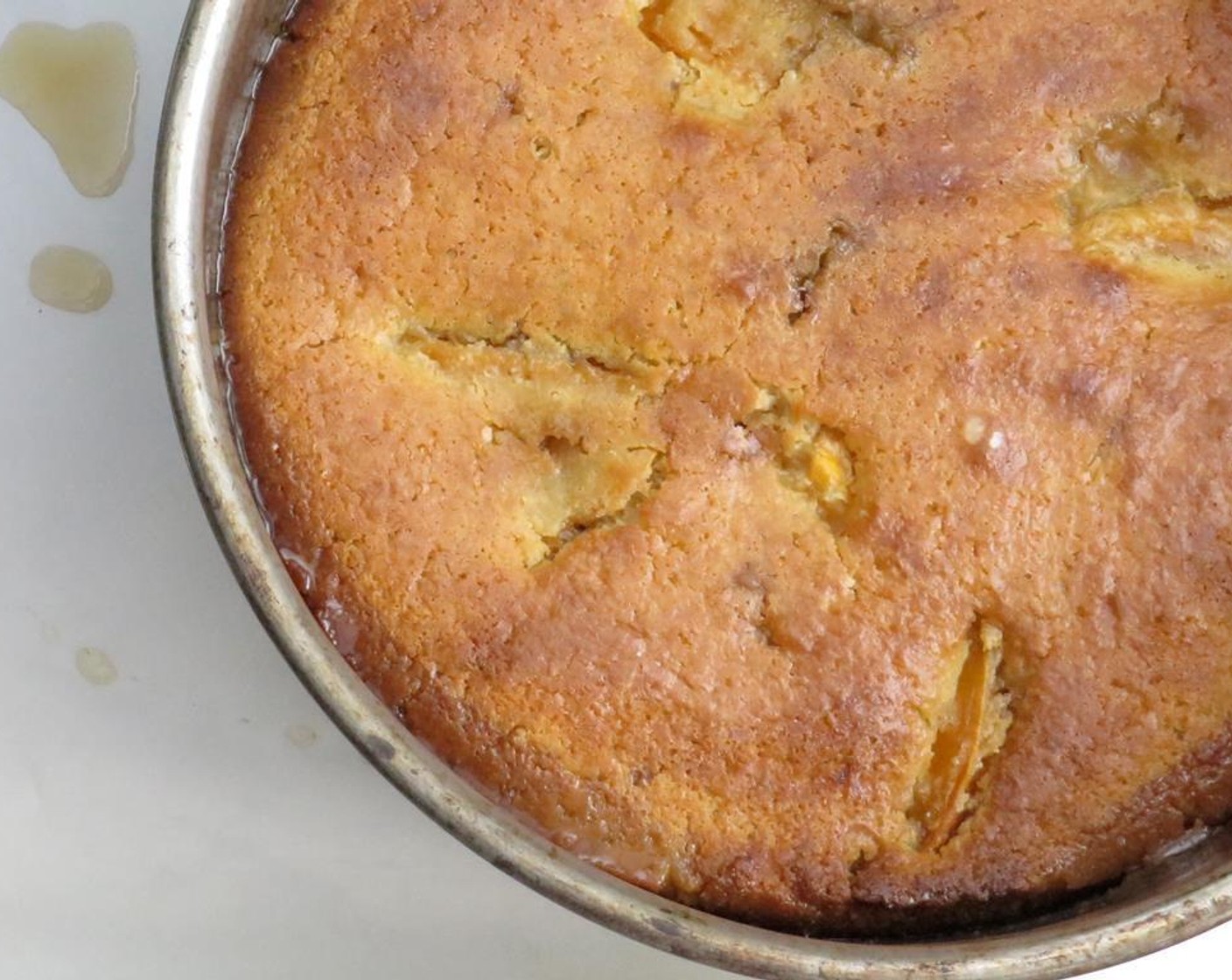 step 5 Remove from oven, and cool for 15 minutes. Run a sharp paring knife around the edges to loosen the cake. Remove the collar from the pan. Set a cake plate on top of the cake, and quickly invert the cake onto the plate. Remove pan bottom.