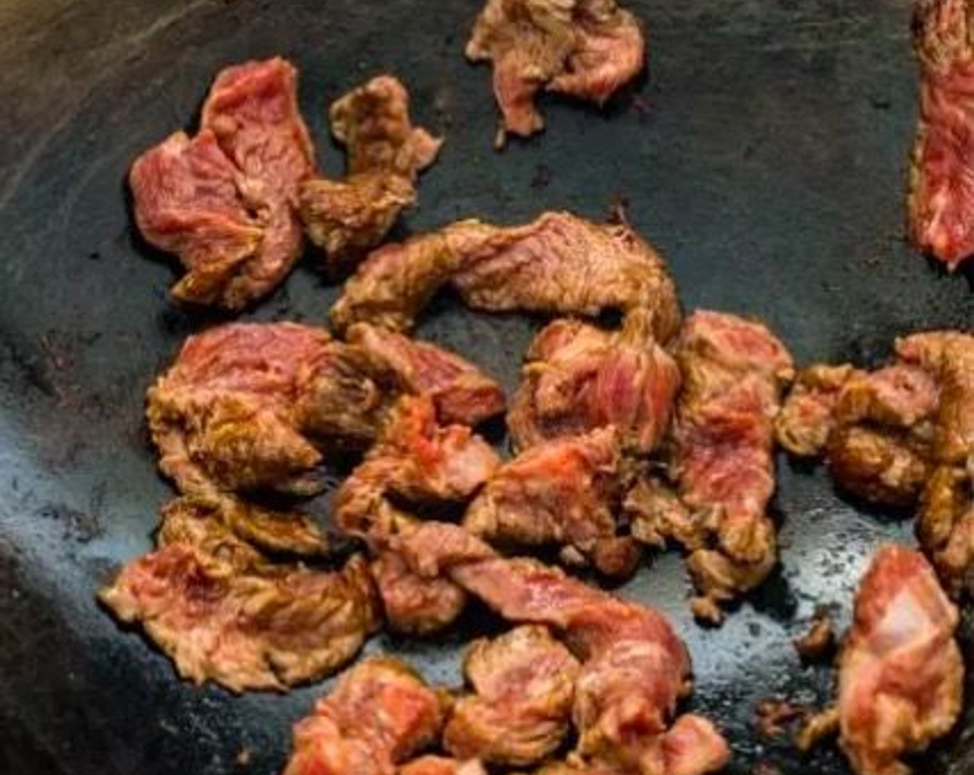 step 4 Heat the Cooking Oil (2 Tbsp) in a wok over medium-high heat. Add the beef strips to the wok. Stir-fry the beef only until they are halfway cooked, then remove them from the wok.