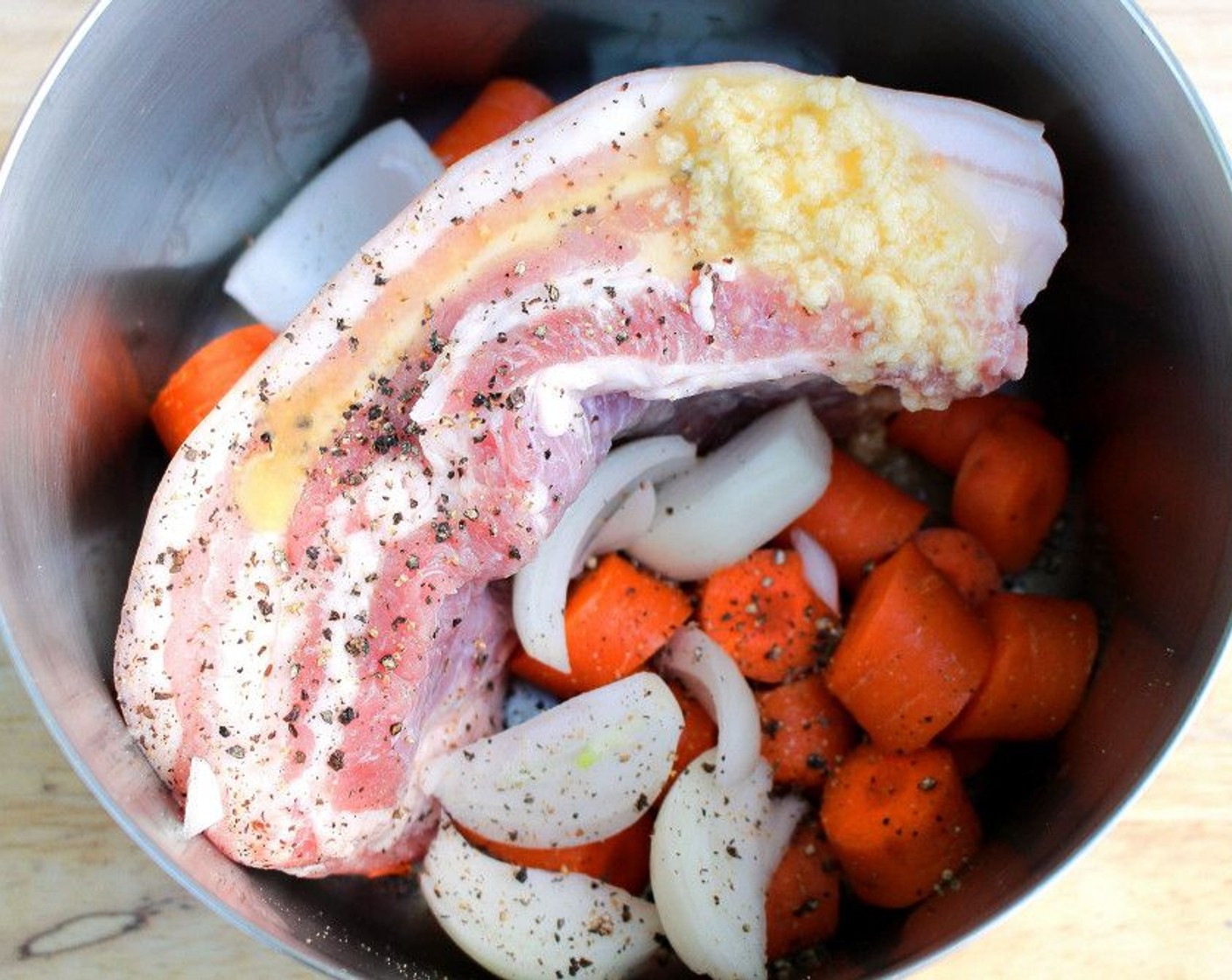 step 1 Simmer Pork Belly (2.5 lb) together with 2 of the Onions (2) and Carrots (2) in enough water to cover everything. Season with Kosher Salt (to taste), Garlic Paste (to taste), and Ground Black Pepper (to taste). Simmer until the belly is tender but not falling apart.