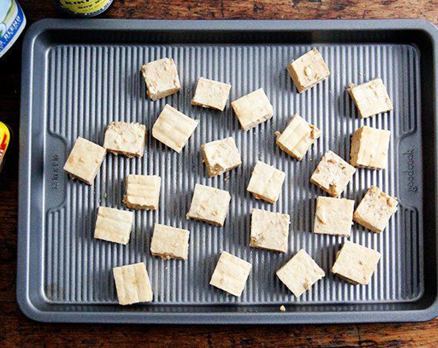 step 5 Remove the tofu from the towels, and cut into one-inch cubes. In a large bowl, gently toss the tofu with Olive Oil (1 Tbsp), the Soy Sauce (1 Tbsp) and the Corn Starch (1 Tbsp) until evenly coated. Spread out on the parchment-line sheet pan.