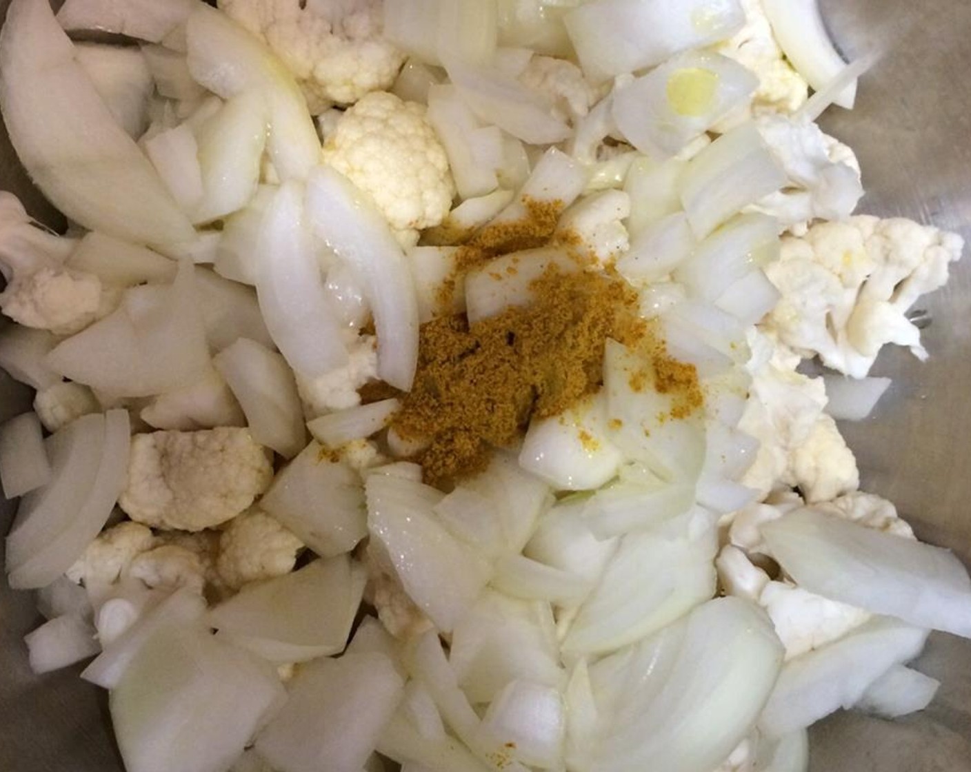 step 2 Slice the Yellow Onion (1). Remove the florets from the Cauliflower (1 handful). Toss the cauliflower florets, sliced onion, Curry Powder (2 Tbsp) and Olive Oil (2 Tbsp) together in a mixing bowl.