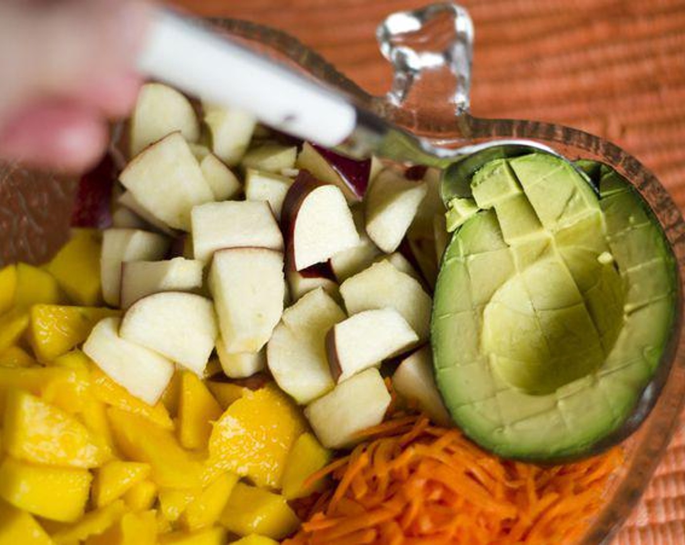 step 2 Toss together the Avocado (1) cut into 1/2-inch dices, Apple (1), Mangoes (2), Carrots (3), Salad Greens (8 cups), and dressing.