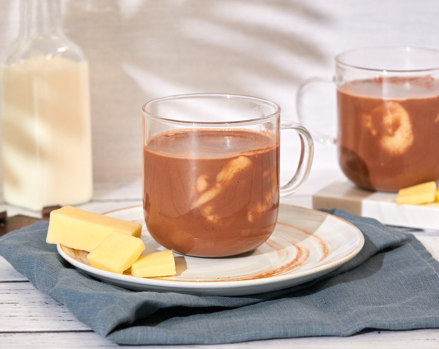 step 5 Evenly pour the hot chocolate mixture into each mug. Let the cheese melt for a bit before serving with a spoon.