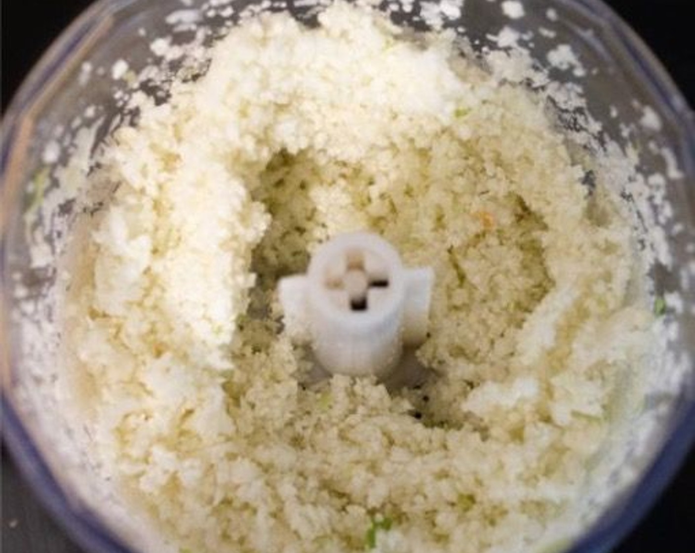 step 1 In a food processor, pulse the Cauliflower (1/2 head) until it reaches your desired “rice” consistency. Alternatively, you can grate the cauliflower with a grater.