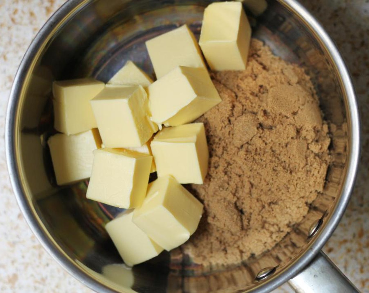 step 3 Place the Unsalted Butter (1 cup), Sea Salt (1 pinch), and Brown Sugar (1 cup) in a saucepan over a medium heat, stirring constantly until melted together.