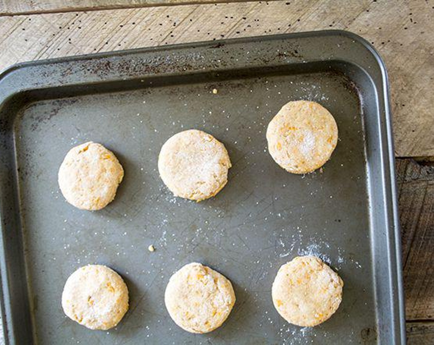 step 6 Turn out dough on a lightly floured surface, form a circle, and flatten it until it is about ¾-inch thick. Using a 2-inch round cutter, carefully cut out biscuits.