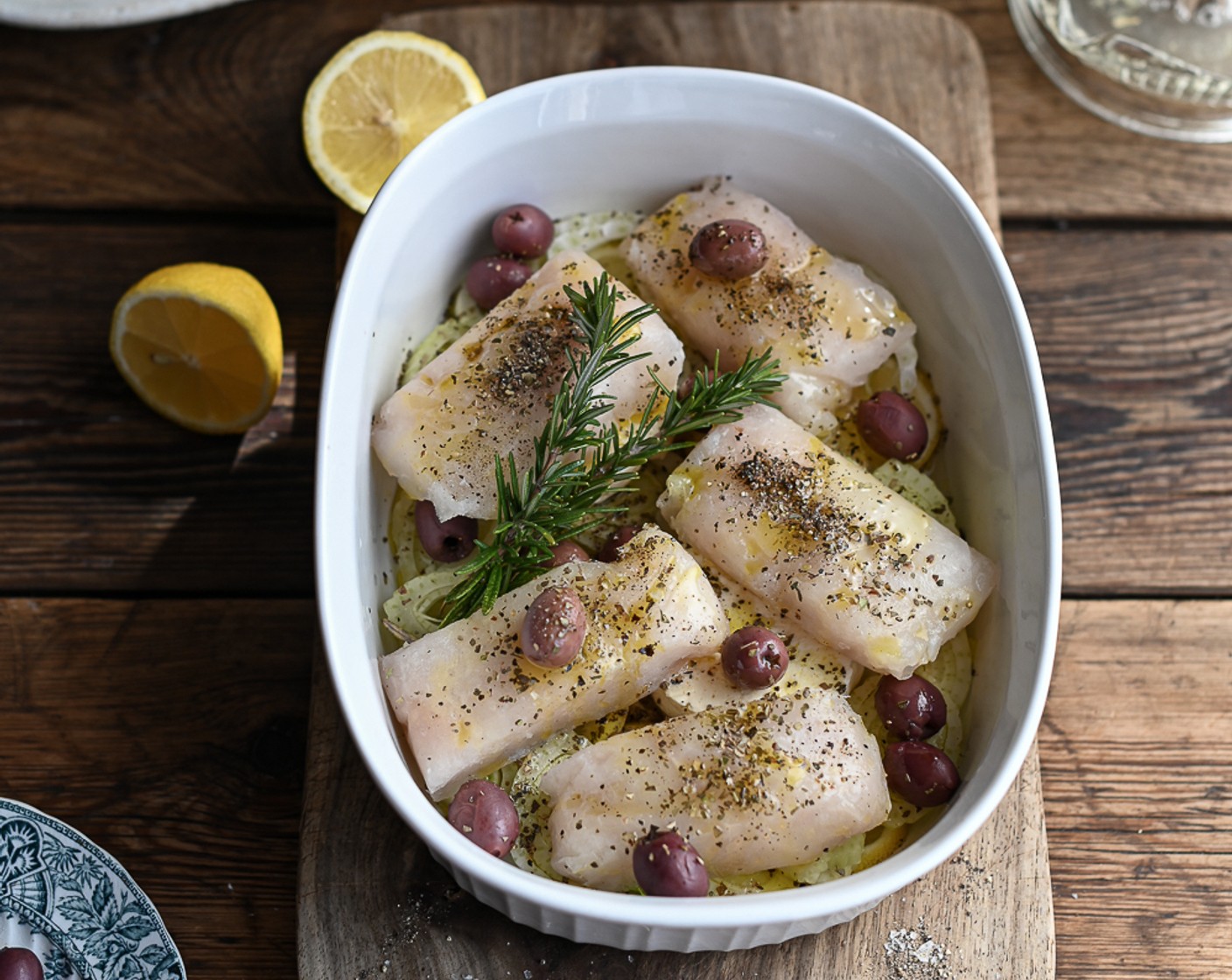 step 5 Juice the remaining Lemon (1/2) and add to the dish. Season the hake with the Dried Oregano (1 Tbsp) and Smoked Paprika (1/2 Tbsp) and tuck the Fresh Rosemary (2 sprigs) in amongst the fish.