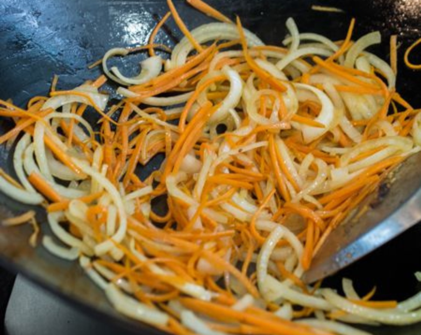 step 7 Stir-fry carrots and onions until just before the onion turns translucent. Set aside.