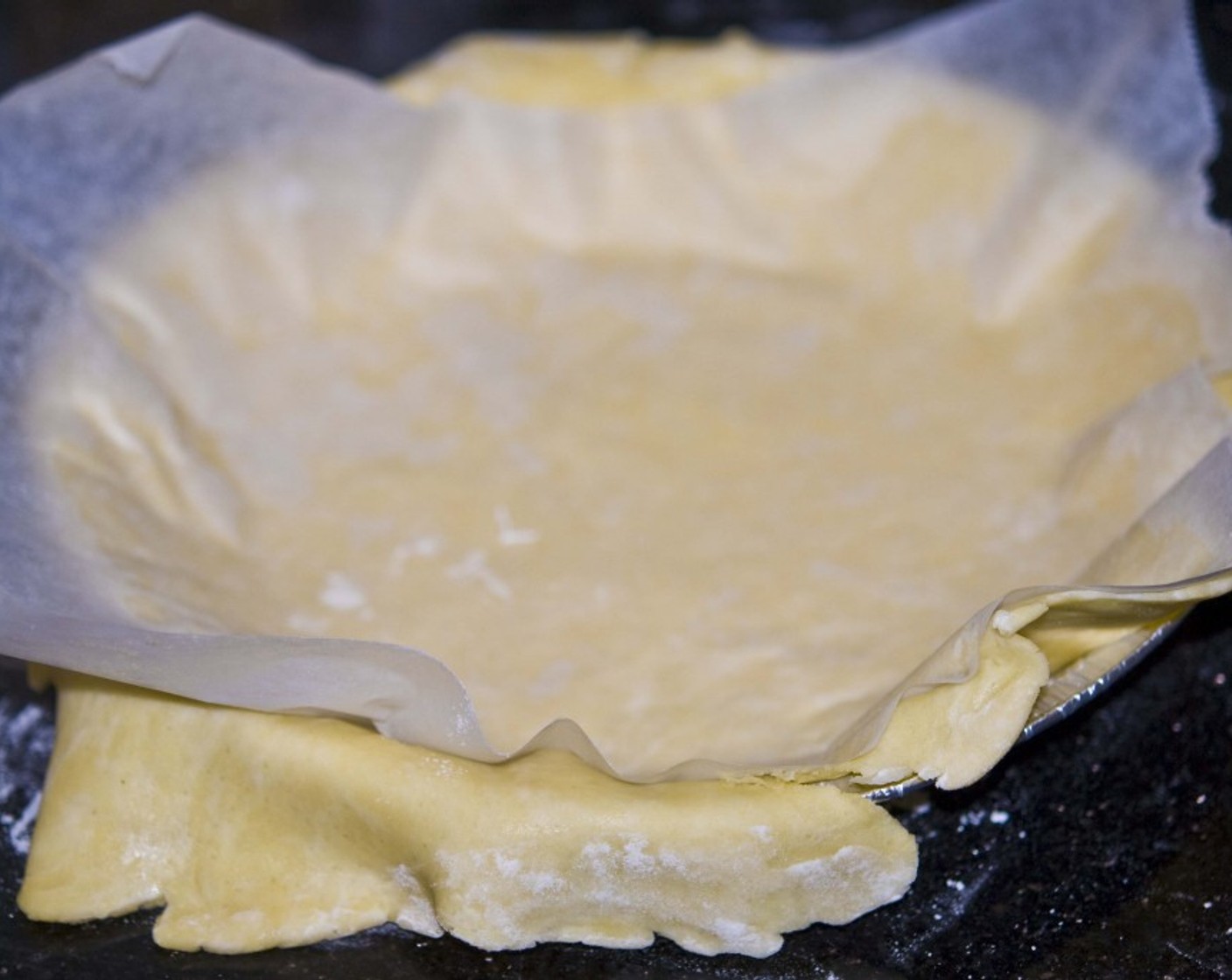 step 6 Next transfer the dough to a pie pan by turning it upside down and gently taking off the baking sheet.