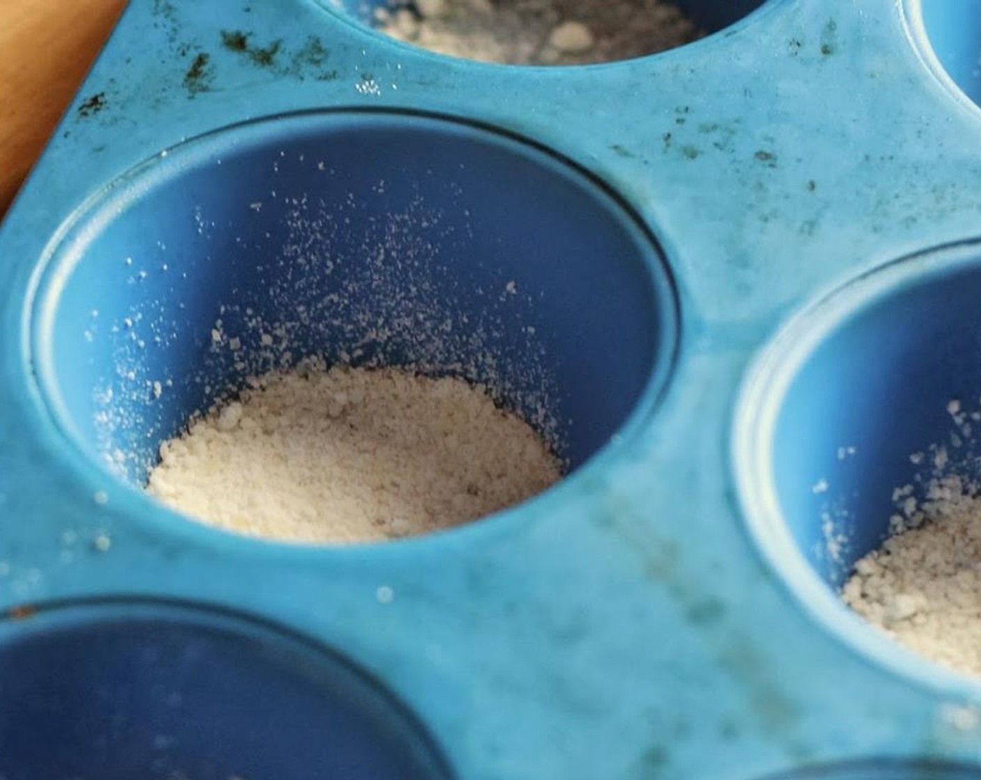 step 2 Spray the bottom of a large cup muffin pan with Nonstick Cooking Spray (as needed). Sprinkle the bottom of each muffin cup with a teaspoon of Parmesan Cheese (1 cup).