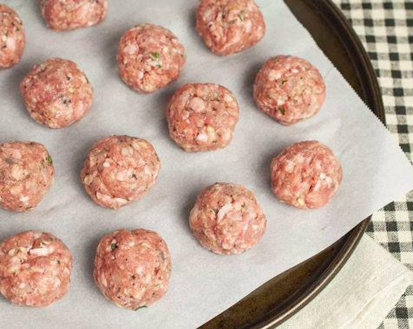 step 2 Gently combine with your hands or a wooden spoon. Roll mixture into 17-18 evenly-sized meatballs, approximately 1 1/4 ounces each.