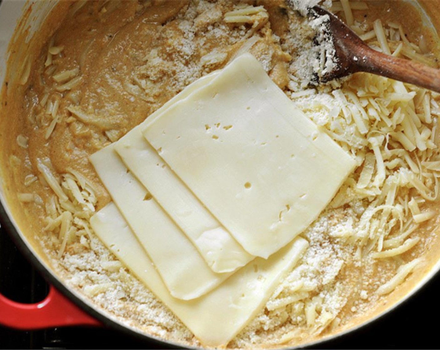 step 7 Turn off the heat and add the Cheddar Cheese (2 cups) (reserve a bit for the topping), Parmesan Cheese (1/2 cup) (reserve a bit for the topping), and Fontina Cheese (1/4 cup). Stir until the cheeses melt and the sauce is evenly incorporated together.