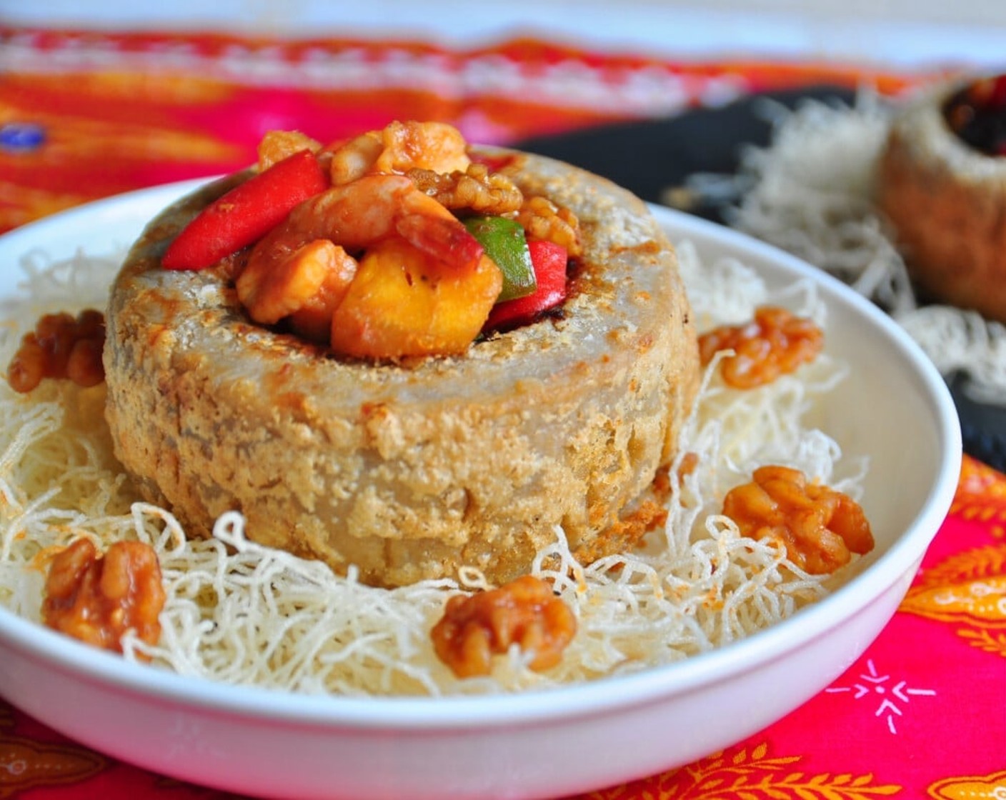 step 17 Place the yam basket on top of the crispy rice vermicelli. Fill the middle of the yam ring with the prawn filling and walnuts. Serve immediately and enjoy!