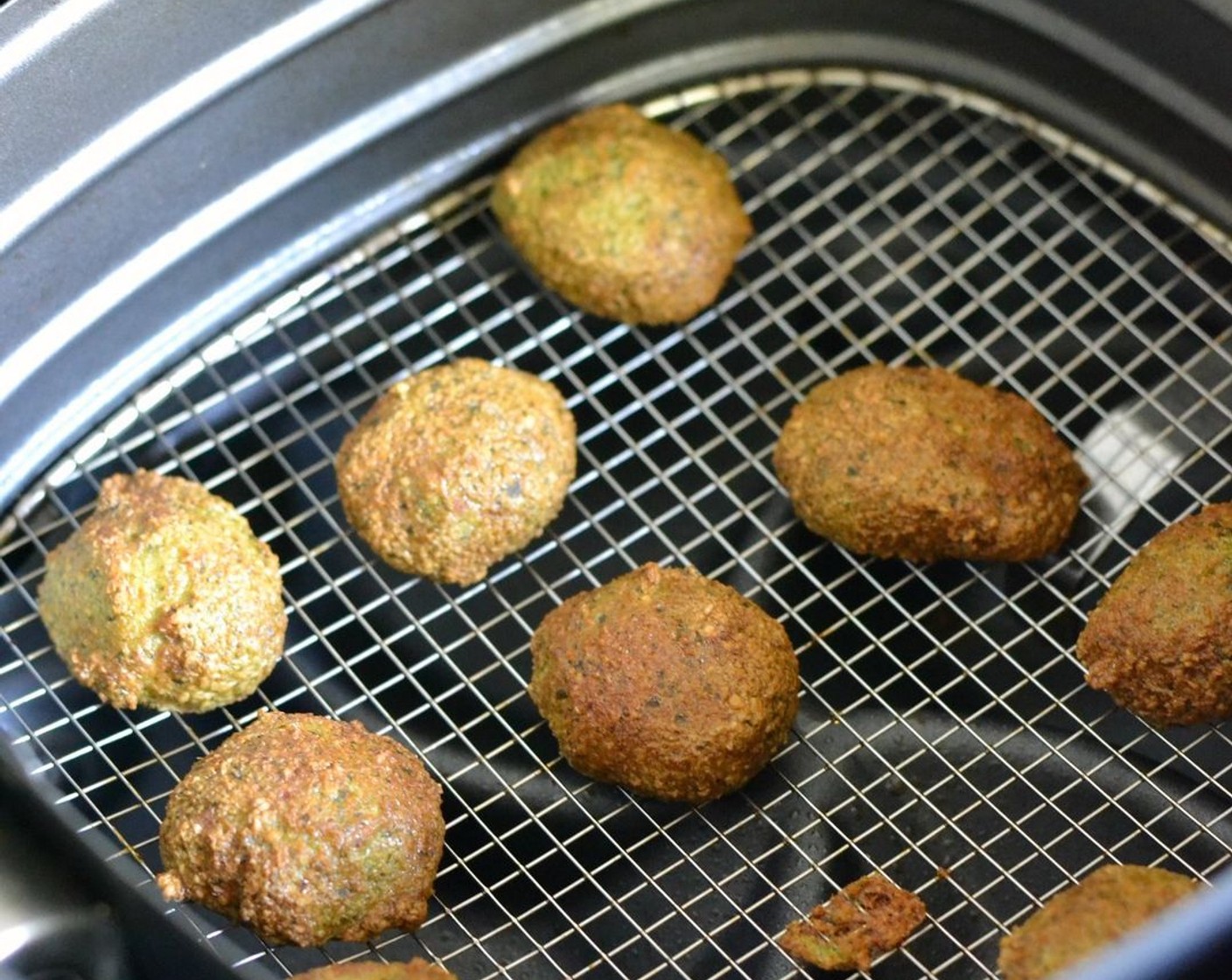 step 5 Spray the falafel balls with oil and then raise the heat to 355 degrees F (180 degrees C). Bake for another 5-10 minutes or until they turn a nice golden brown.