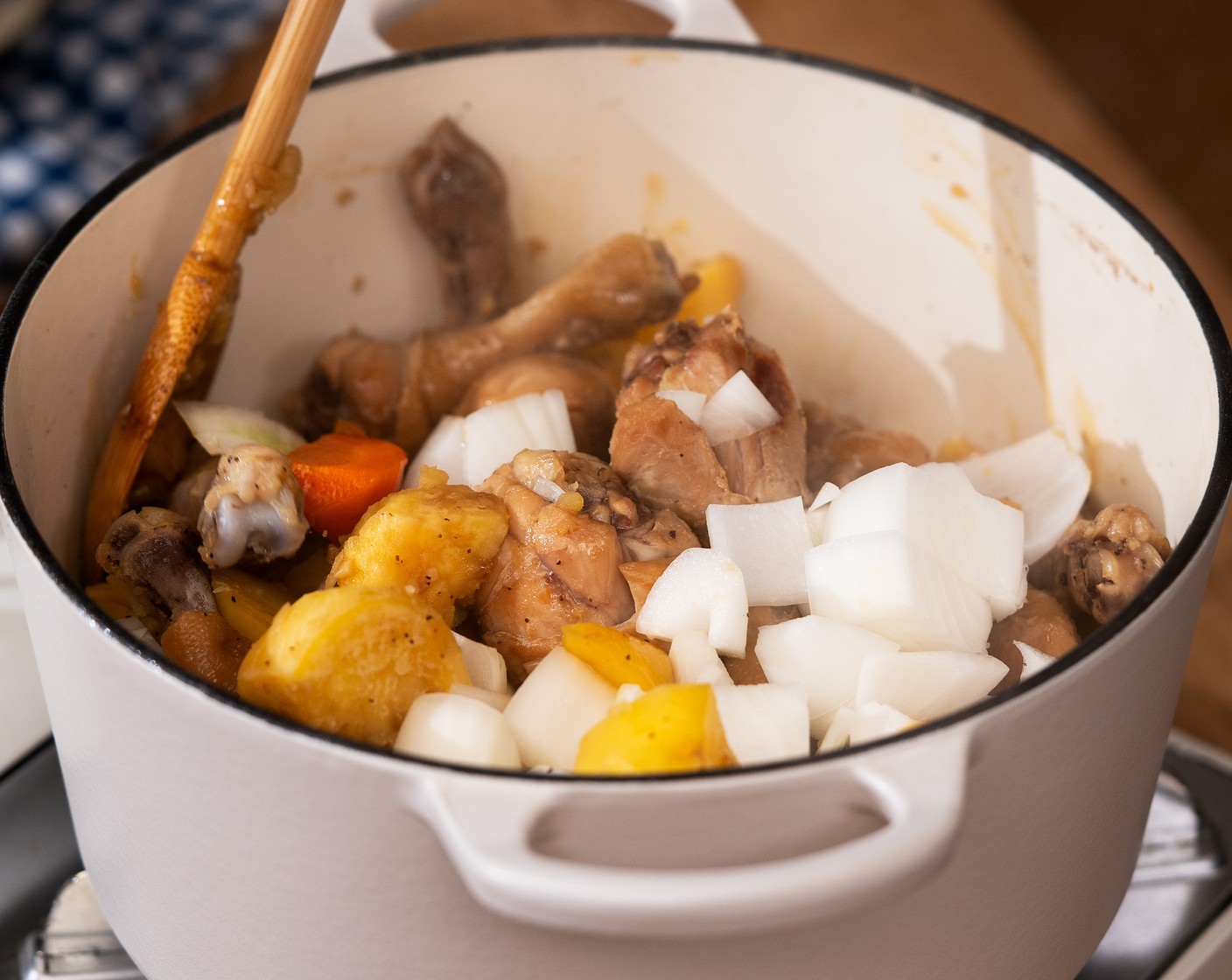 step 7 Add Yellow Onion (1) and stir. Then cover with a lid and simmer for 10 more minutes, stirring occasionally.