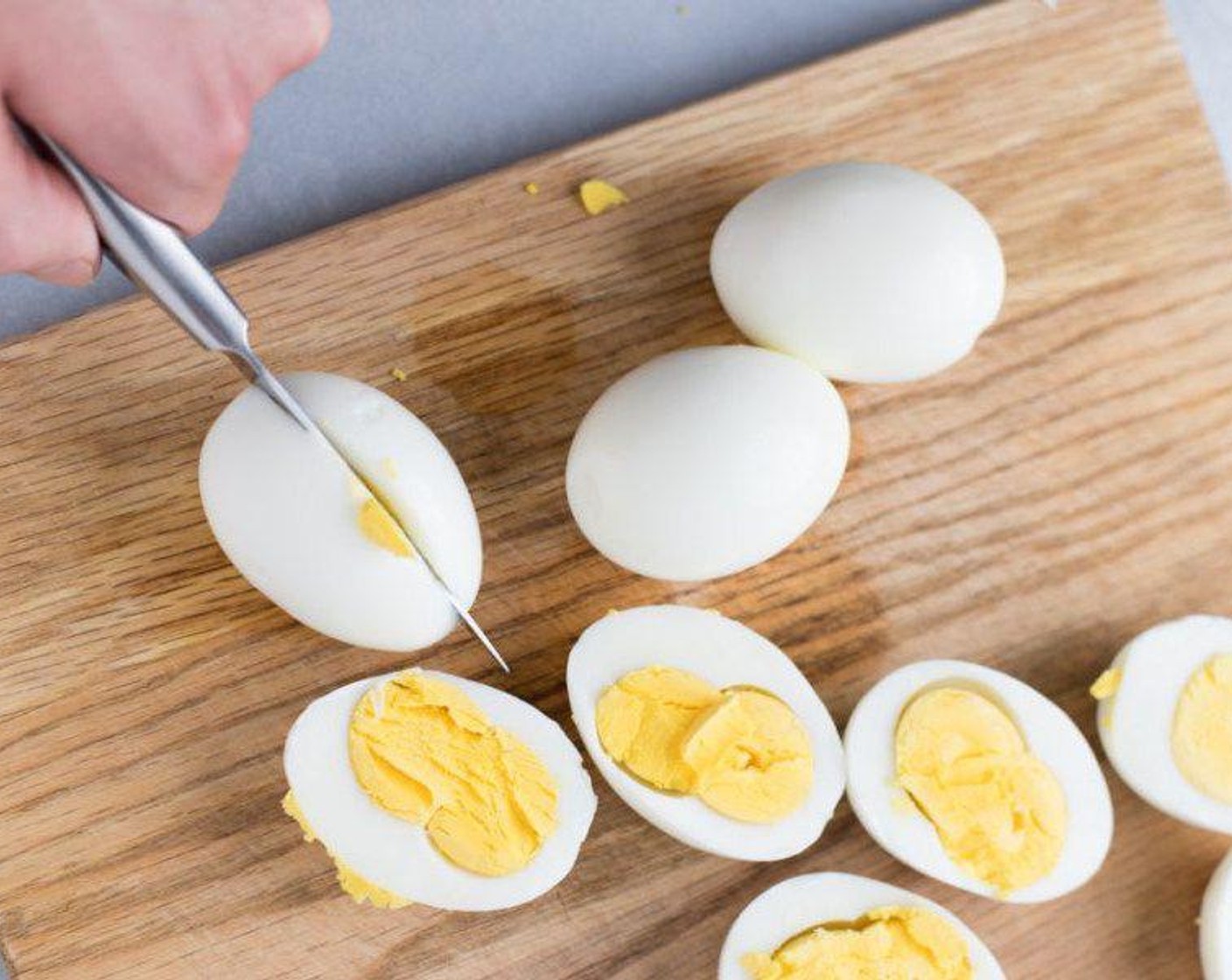 step 4 Cut eggs in half, putting yellow yolks into a medium-sized mixing bowl. Put egg whites to the side for filling later.