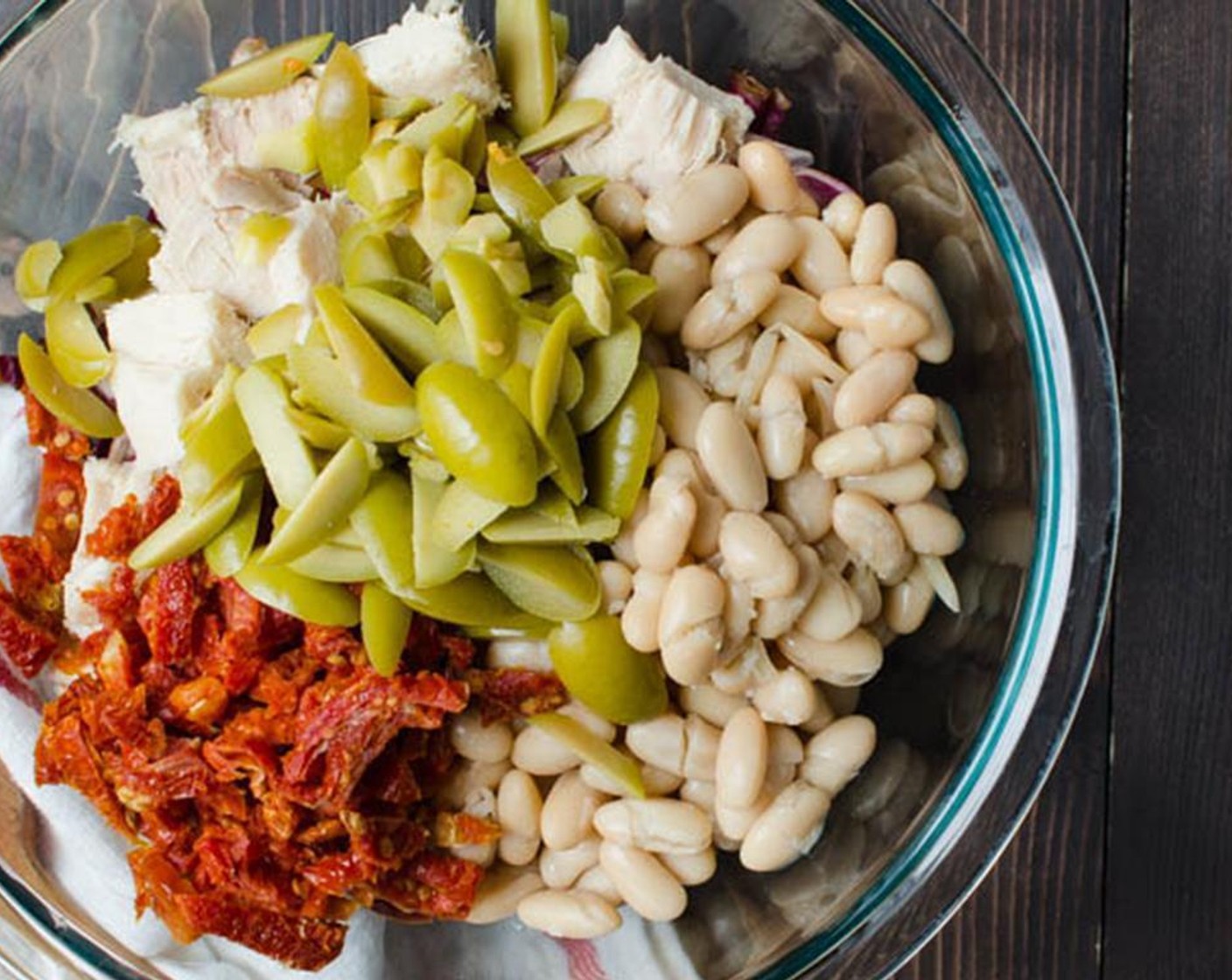 step 6 Add the Canned Cannellini White Kidney Beans (4 1/4 cups), Sun-Dried Tomatoes (1 cup), and Olives (1 cup). Toss to combine and set aside.