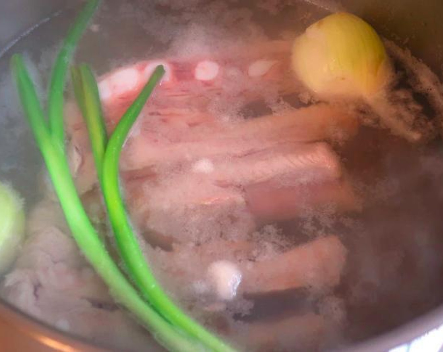 step 1 Simmer Pork Ribs (2 lb) with Scallions (2 stalks), Onion (1), Garlic Paste (1 Tbsp), Tomato Paste (1 Tbsp) and Kosher Salt (to taste) and Cayenne Pepper (to taste).