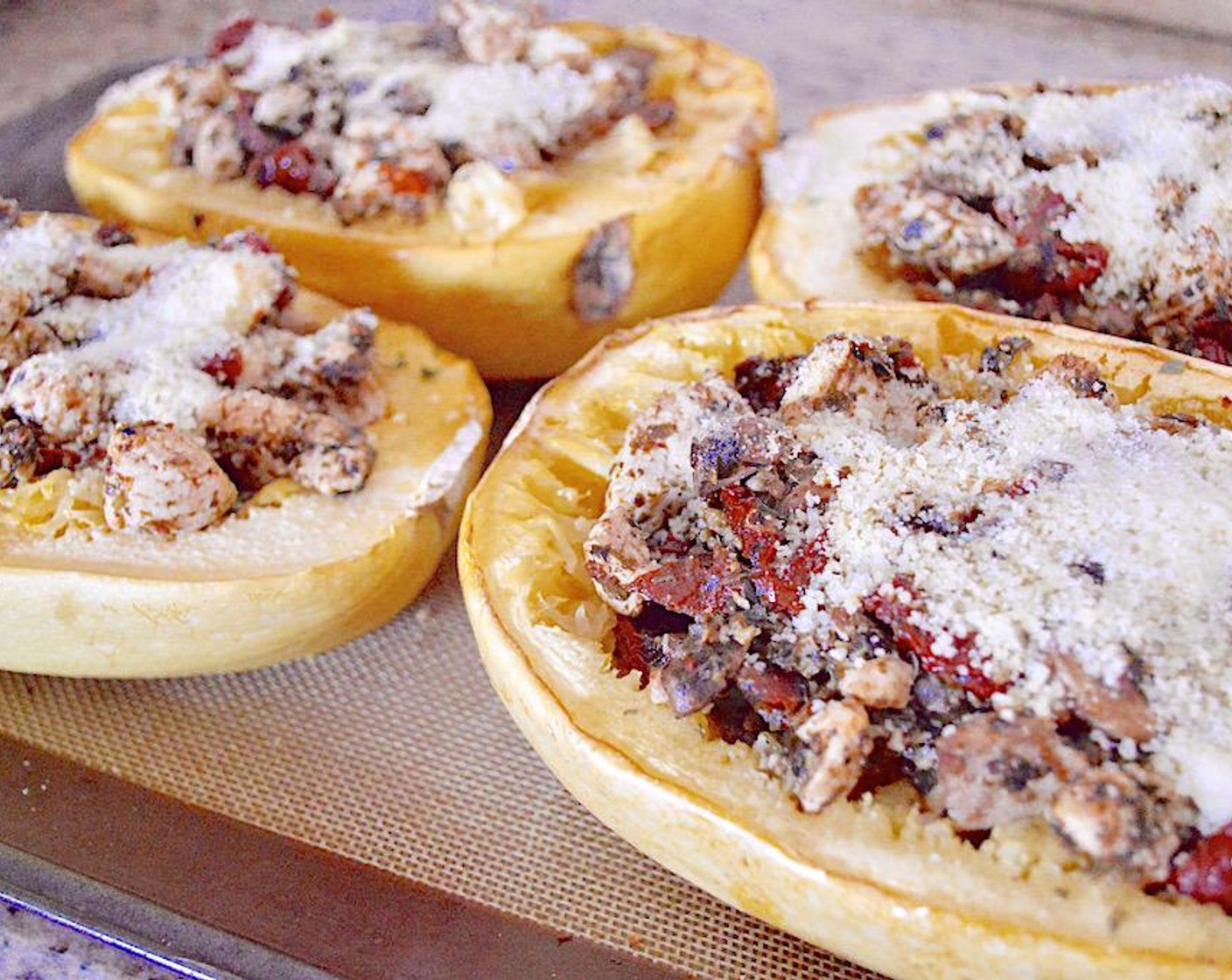 step 6 Divide the chicken mixture evenly among the squash boats and stuff them well. Finally, top each stuffed squash with Grated Parmesan Cheese (1/4 cup). Put it back into the oven to meld together for 6-8 minutes.