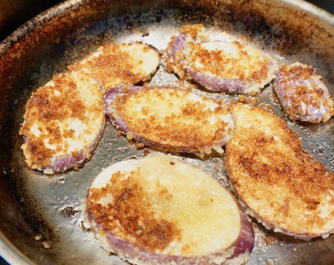 step 8 Coat another skillet completely with the Oil (1/4 cup) and heat up over medium-high heat. Add eggplant and fry until golden brown over medium-high heat, 3 minutes per side. Remove to cool, then dice up the fried eggplant.