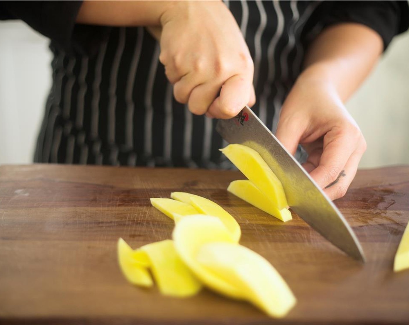 step 3 Peel skin off Mango (1) and remove flesh from pit. Discard pit and dice mango into small pieces, then set aside.