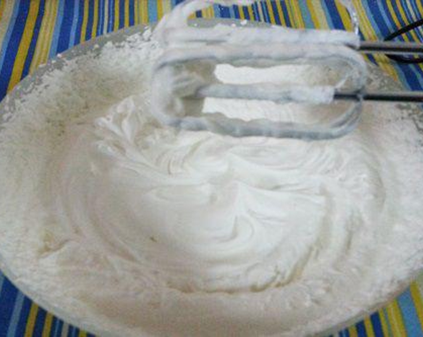 step 2 Pour Kemps Heavy Whipping Cream (2 cups) to a bowl along with the Powdered Confectioners Sugar (1 cup) and Vanilla Essence (1/2 tsp) and whip until soft peaks are formed