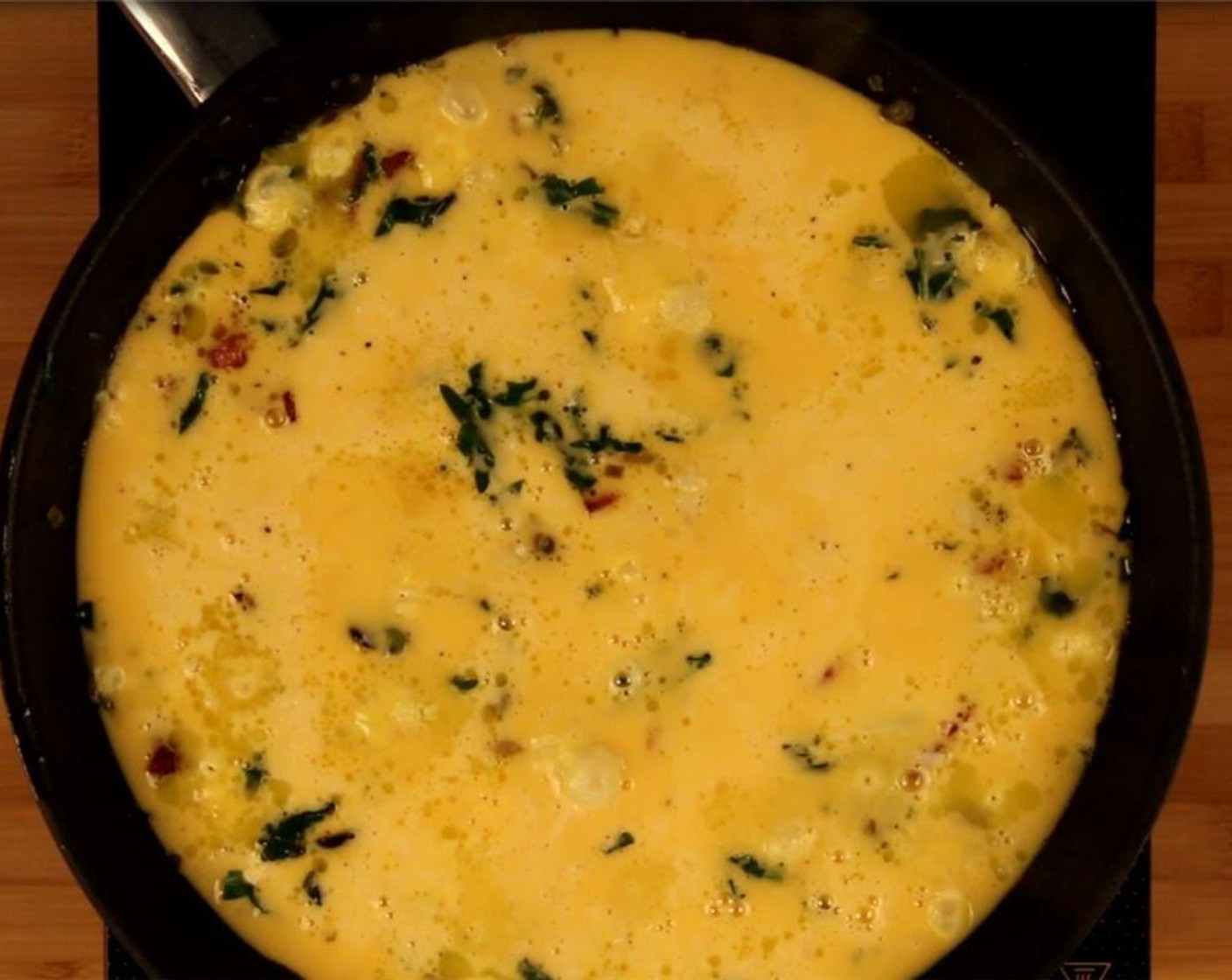 step 7 Pour the egg mixture over the ingredients in the pan. Let cook over medium heat for 5 minutes until the edges begin to come together.