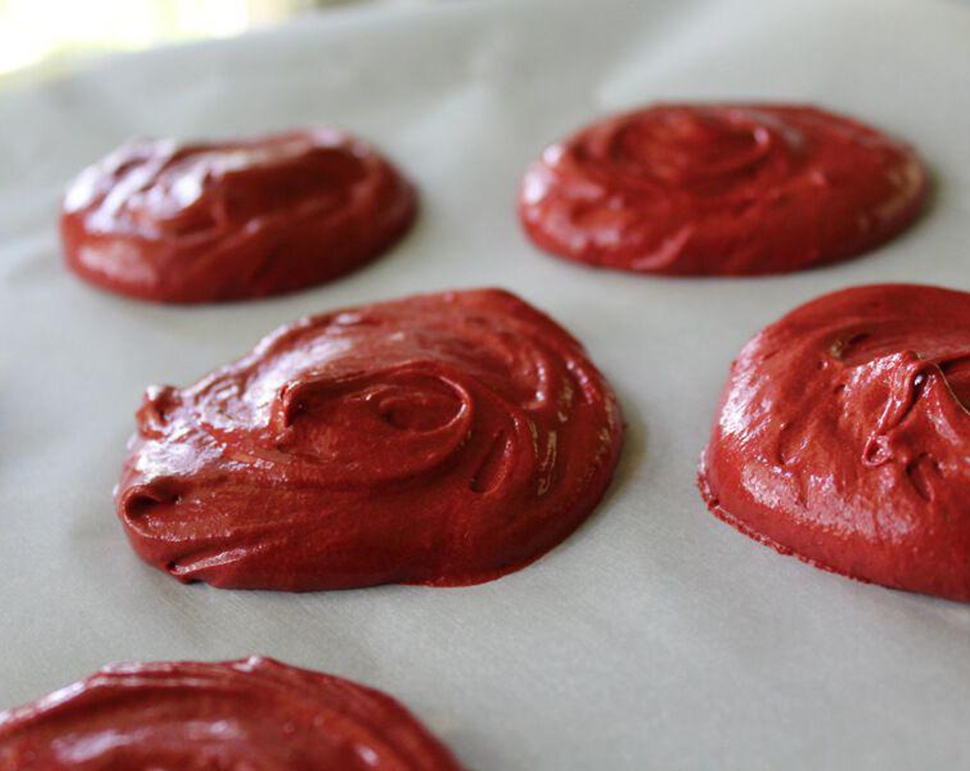 step 4 Using a spoon or scoop, measure even amounts of batter onto the parchment paper. Place them a couple of inches apart to allow for expansion during cooking.