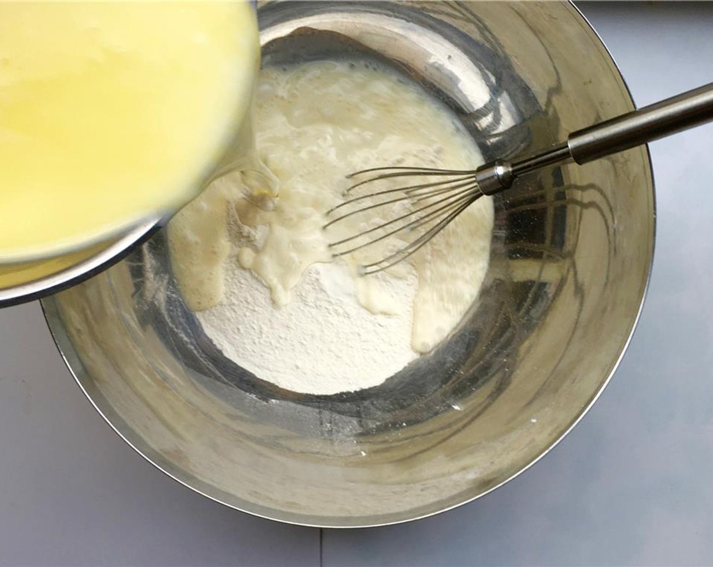 step 3 Sift the Self-Rising Flour (1 2/3 cups) over a large mixing bowl and pour in the cooled butter and milk mixture.