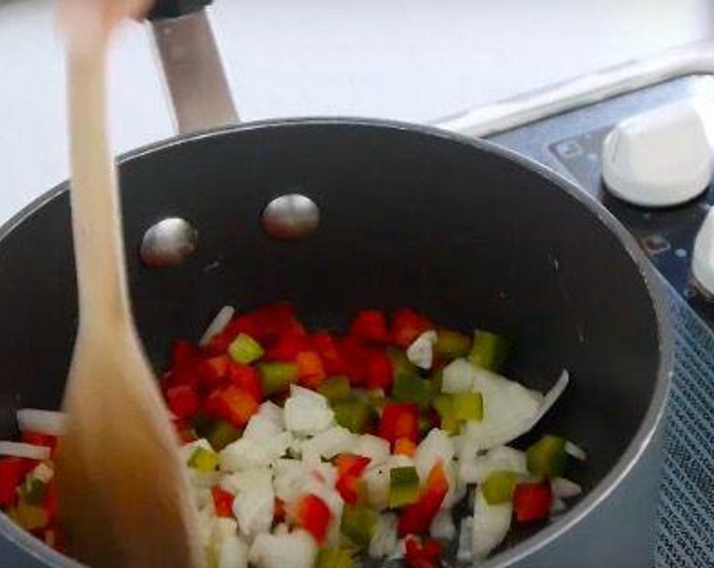 step 2 In a pan, sweat the Onion (1/2), Garlic (2 cloves), Long Green Peppers (1/4), and Red Chili Pepper (1/4) with Vegetable Oil (as needed) until soft.