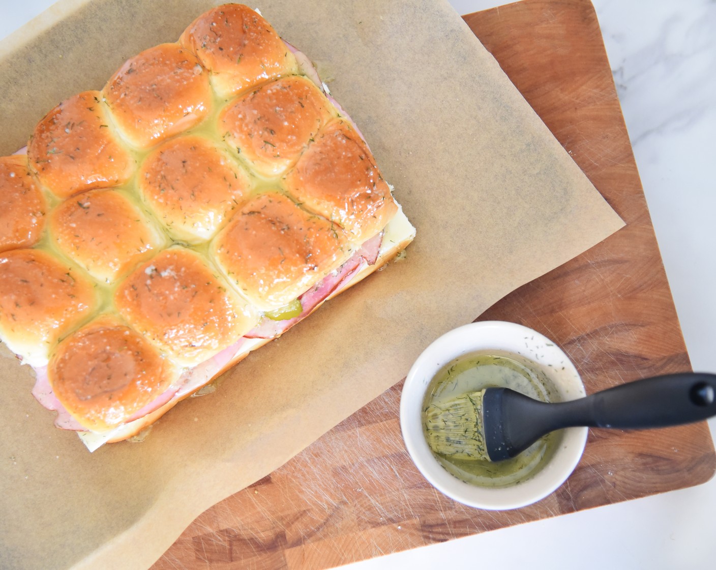 step 10 In a small bowl, mix together the Unsalted Butter (2 Tbsp), Kosher Salt (1/2 tsp), Dried Dill Weed (1/2 tsp), and Simply Organic Garlic Powder (1/4 tsp). Brush the butter mixture over the tops of the rolls.