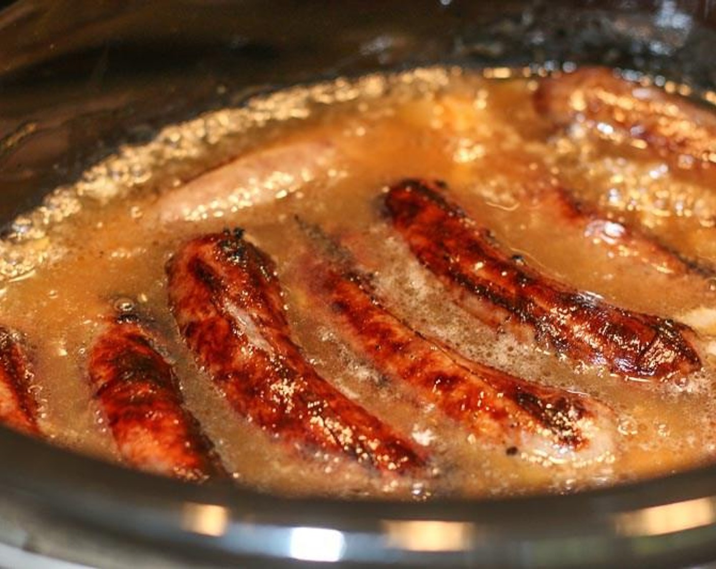 step 5 Add brats to Crockpot. Pour Beer (24 fl oz) over onions and brats. Cook in Crockpot 6 to 7 hours on low.