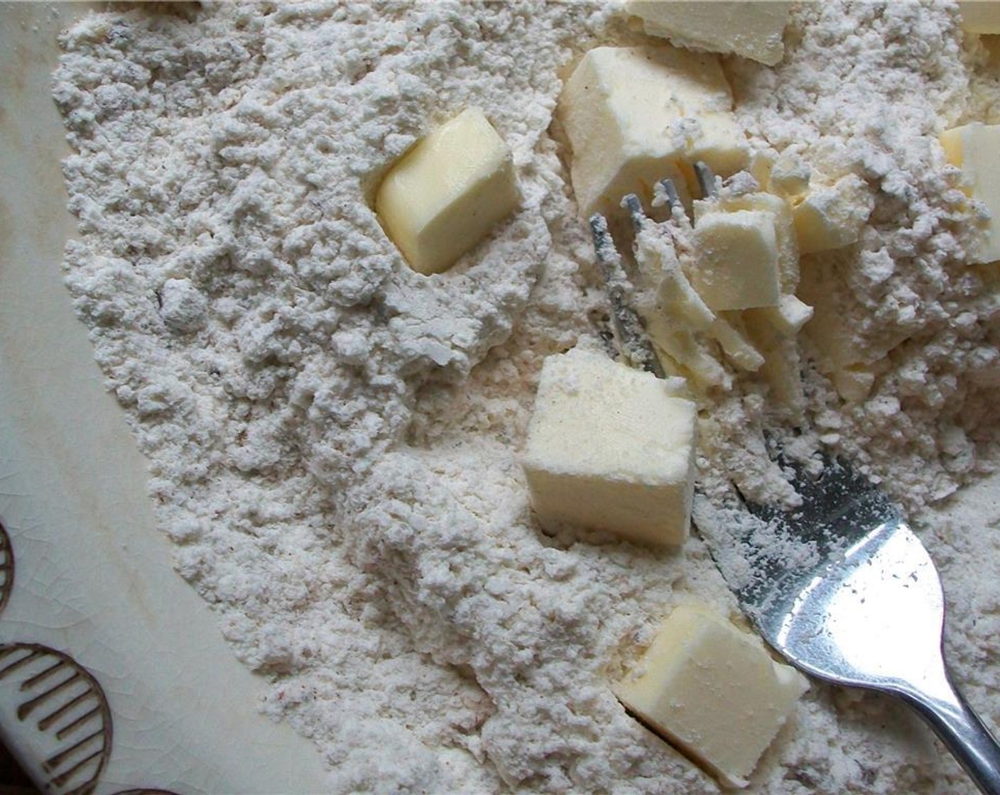 step 2 Mix together All-Purpose Flour (1 cup), Baking Powder (2 tsp), Pecan Halves (2 Tbsp), Salt (1 tsp), Simply Organic Cinnamon, Ground (1/4 tsp), Ground Allspice (1/8 tsp), and Ground Nutmeg (1/4 tsp). Cut in Unsalted Butter (4 Tbsp) until it is the size of peas.